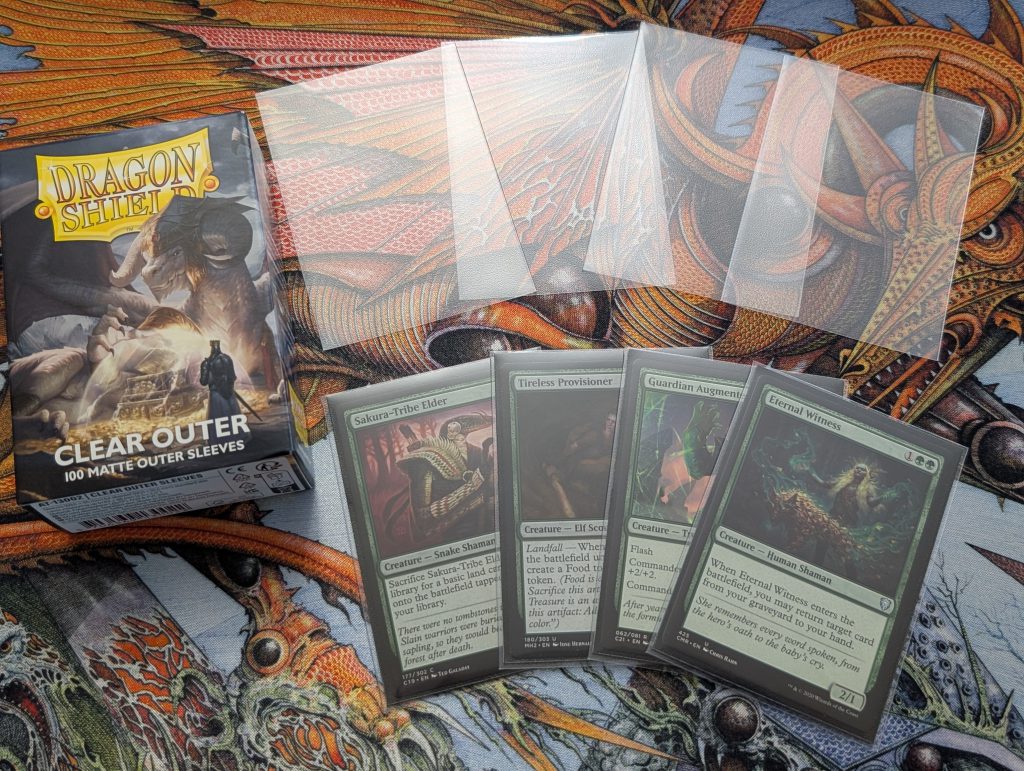 Clear Outer Sleeves by Dragon Shield. The top row is just the sleeves, and the bottom row is Magic cards in the Clear Outer Sleeves.